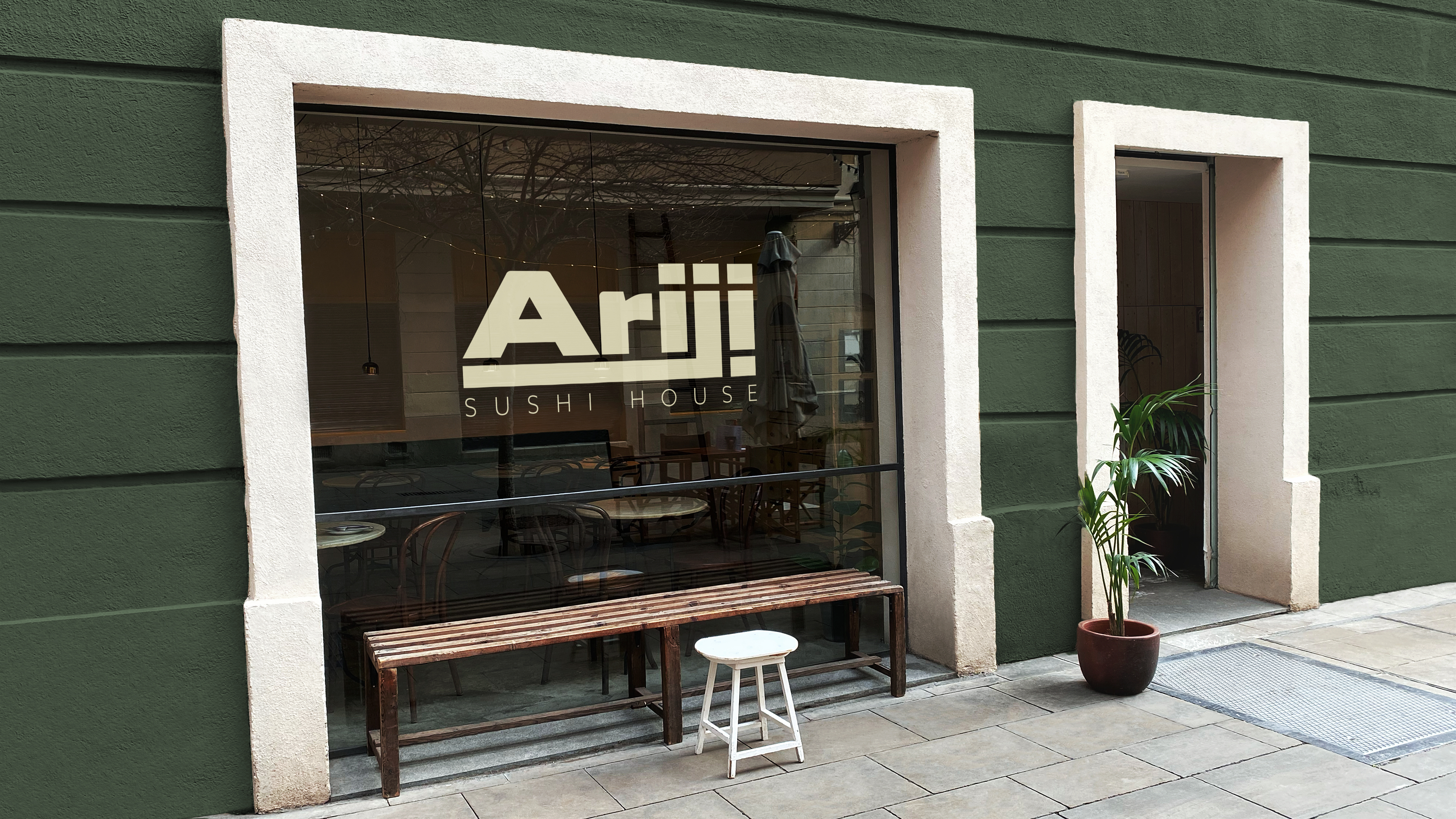 Storefront of Ariji restaurant with ariji logo on window